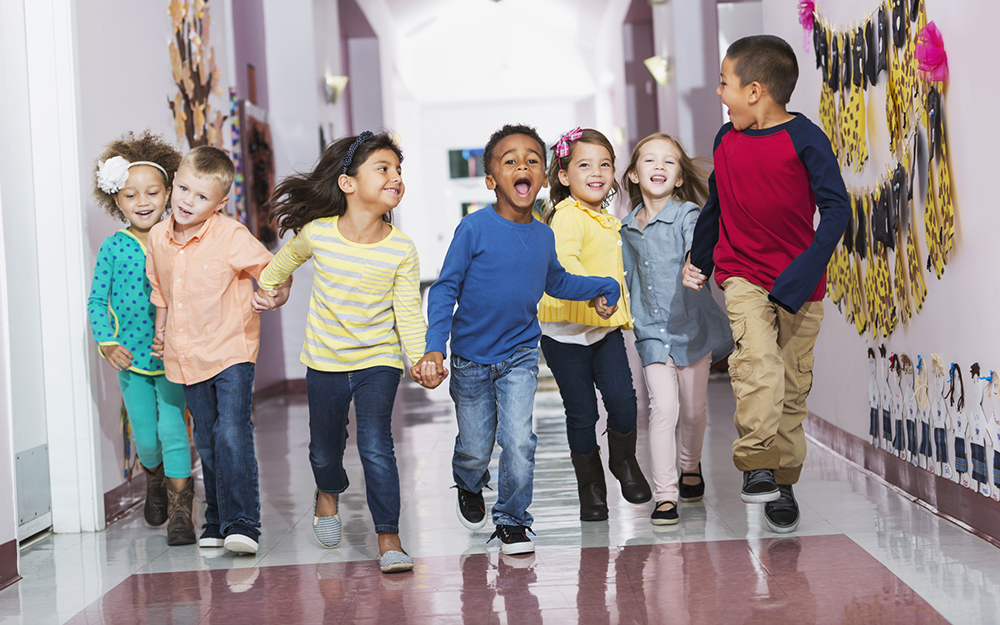 Elementary school kids running down hallway.