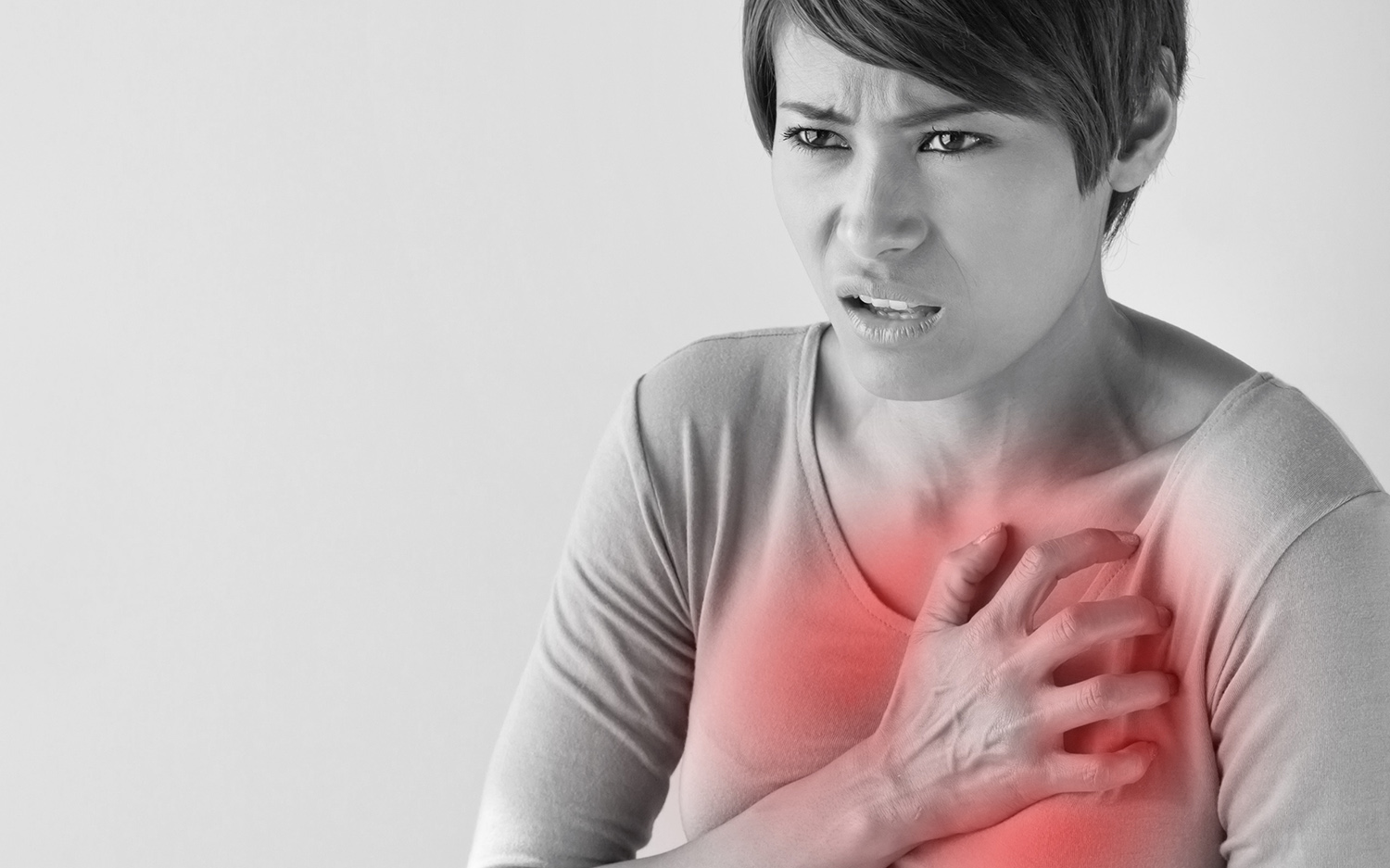 Woman holding her chest in pain.