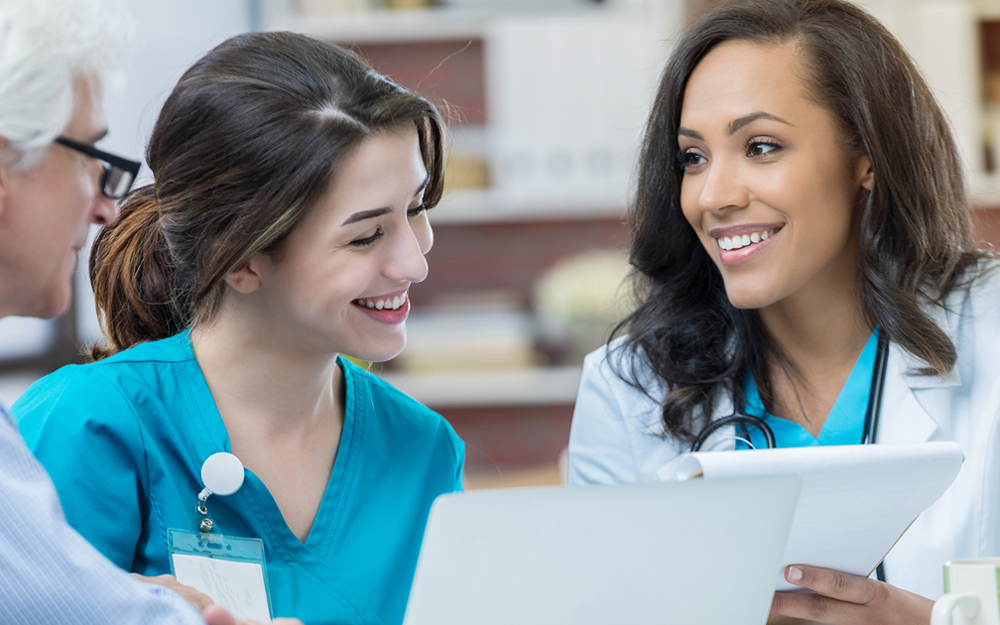Woman doctor talking with hospital staff.