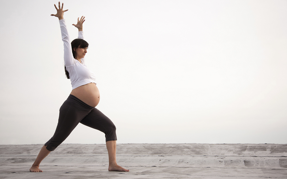 Pregnant woman doing yoga.