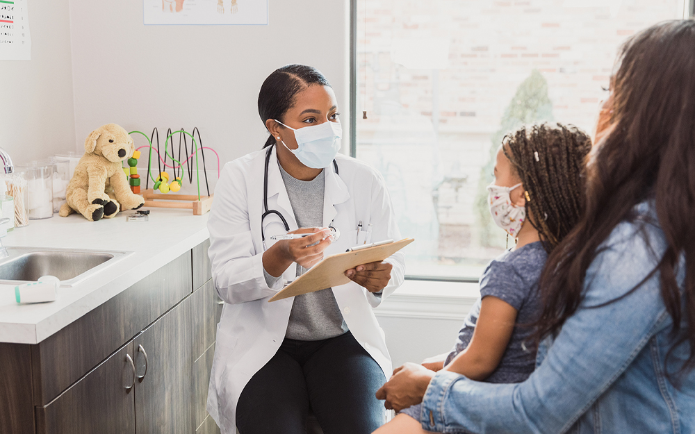 A female doctor talking to a family about clinical trials in children
