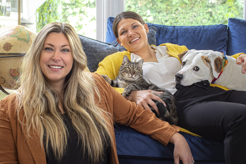 Erin Jackson-Ward with partner Lorryn, Kevin (cat) and Roen (dog) posing for picture