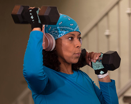 Holly Logan, lifting dumbells.